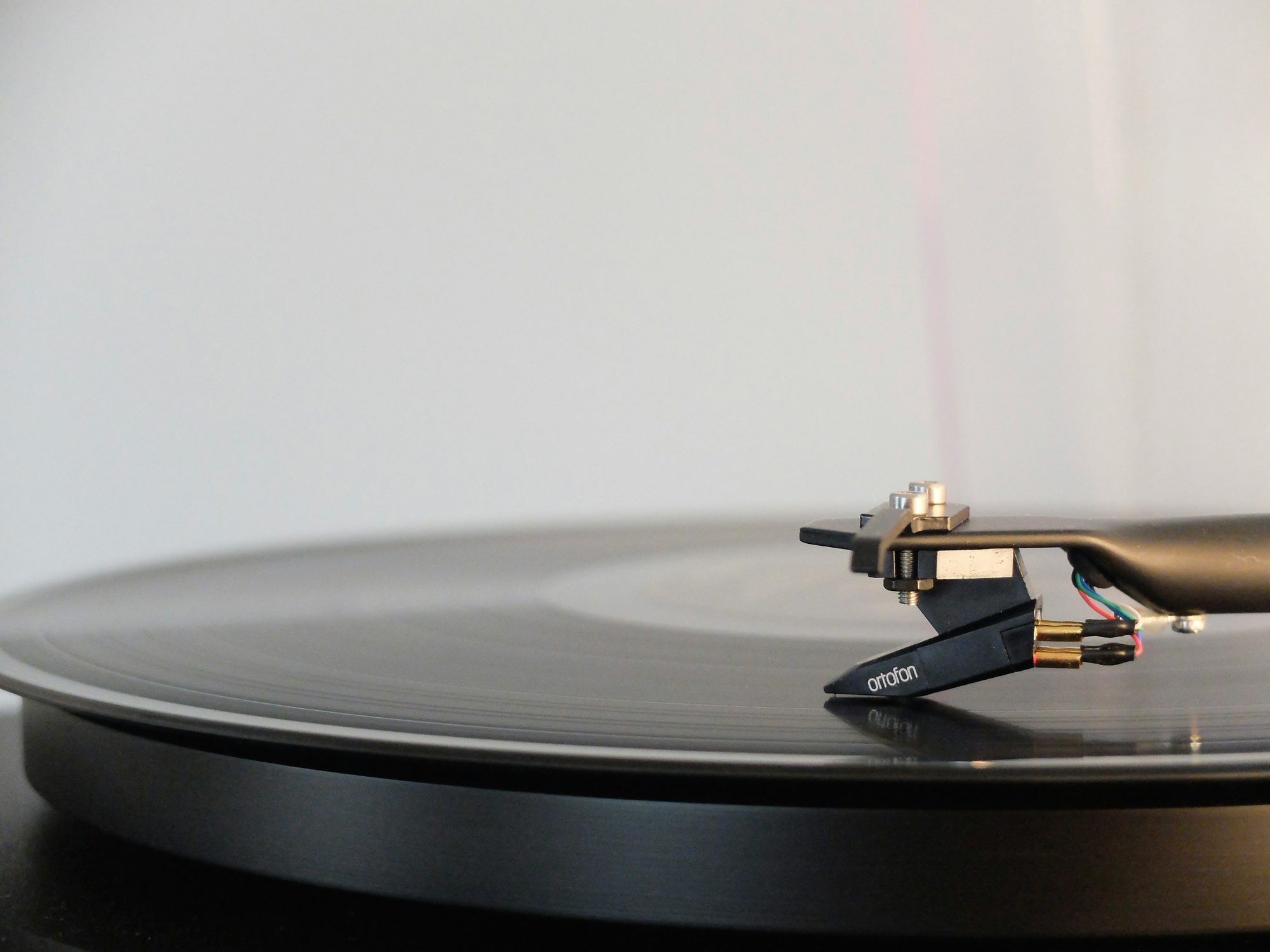A turntable cartridge and tonearm in close detail